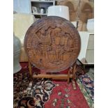 A 20th Century Style Chinese Carved Hardwood Tilt Top Glazed Gate Leg Tea Table With Heavily