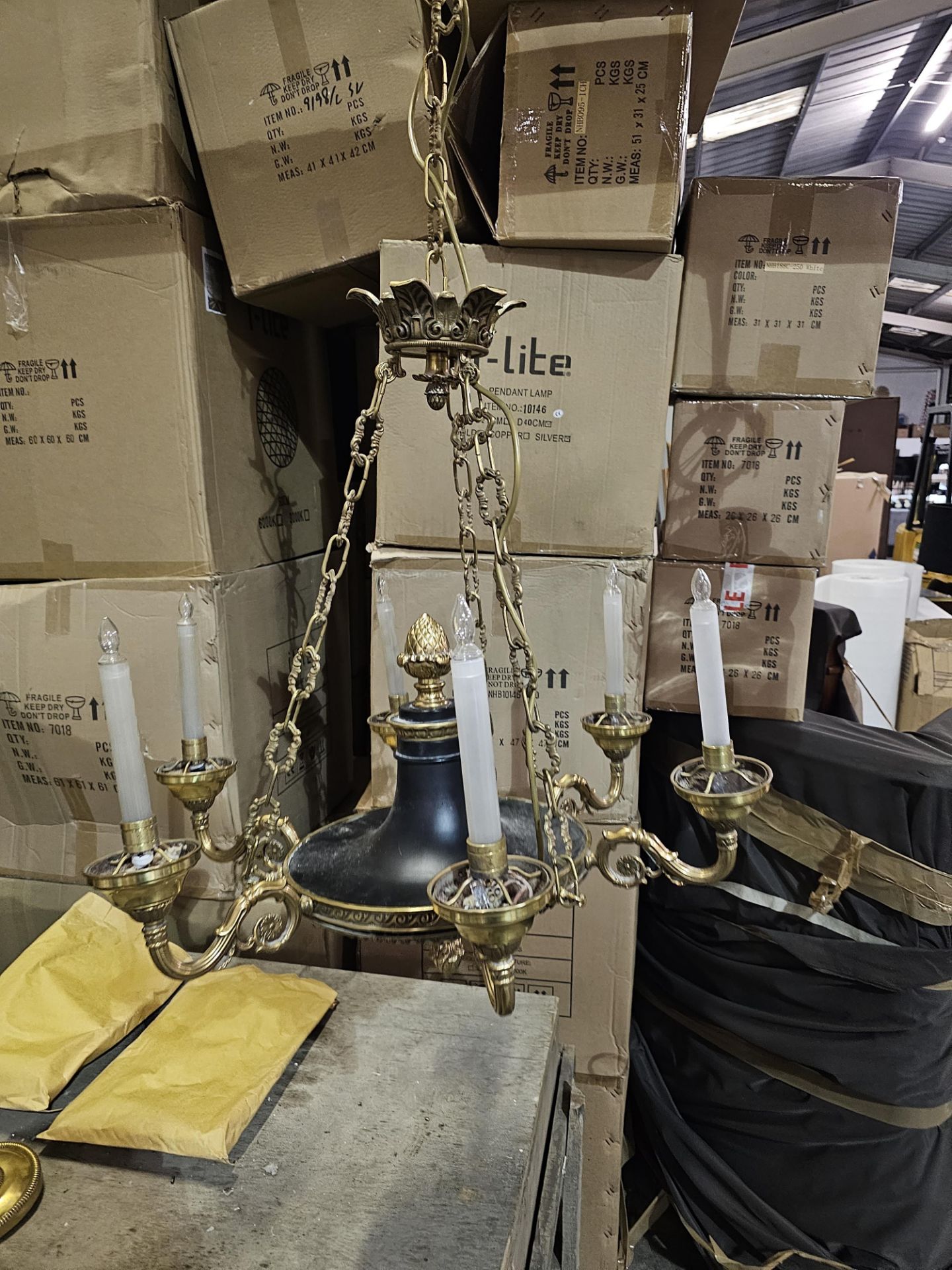 Large French Empire style six-arm bronze chandelier with black tole accents. This chandelier has