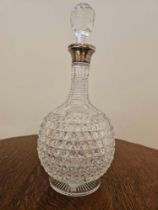 A Glass Cut Decanter With Stopper Of Bottle Form With Silver Assay Marked Collar London 1973 32cm