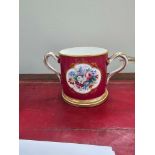 A Victorian Porcelain Loving Cup Claret Ground Reserve With Quatre Lobed Panel Of A Spray Of Flowers