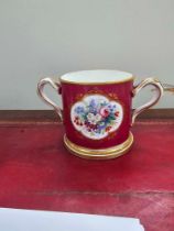 A Victorian Porcelain Loving Cup Claret Ground Reserve With Quatre Lobed Panel Of A Spray Of Flowers