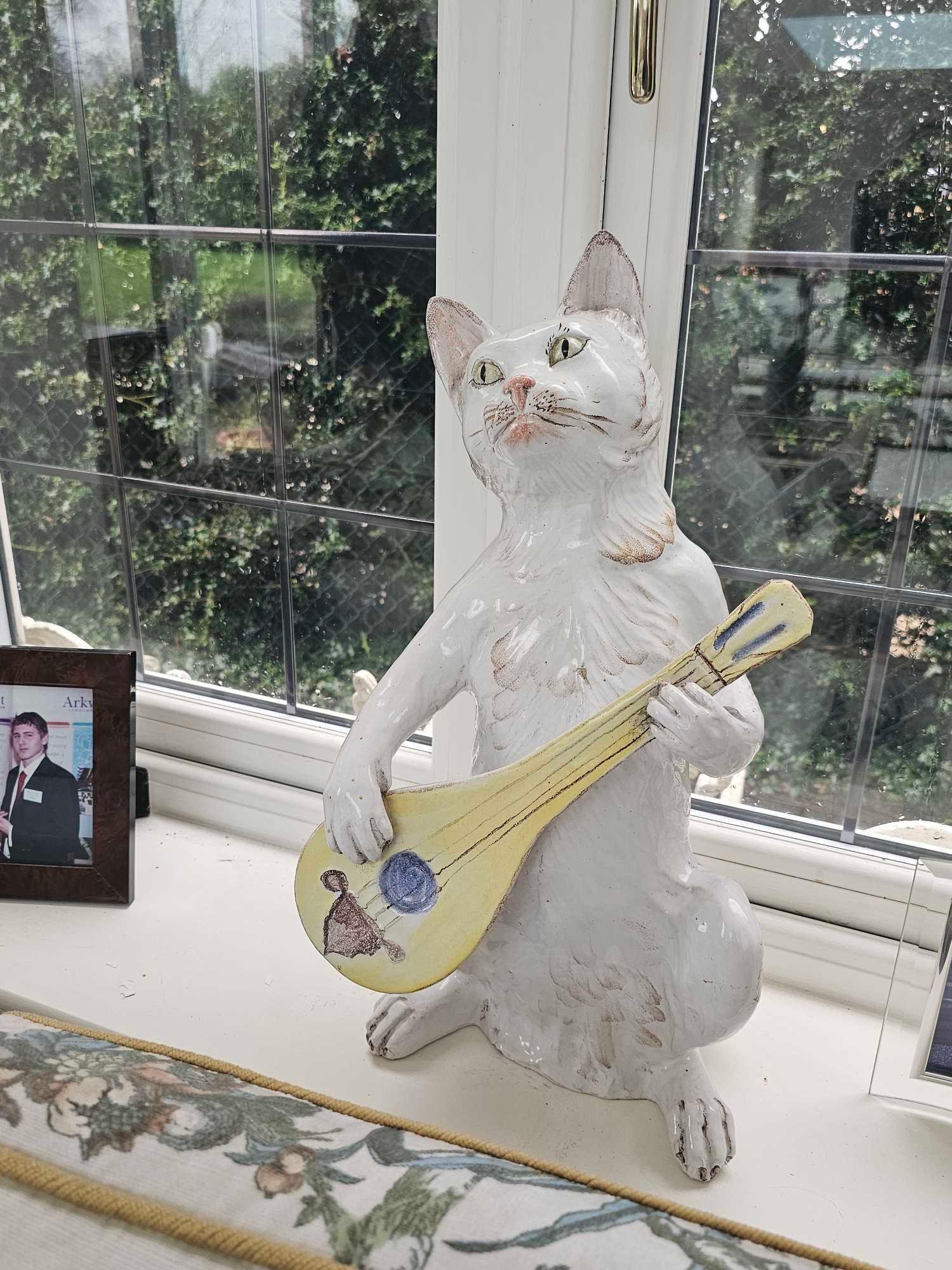 A Continental Porcelain Figurine Of A Cat Playing A Mandolin 48cm High