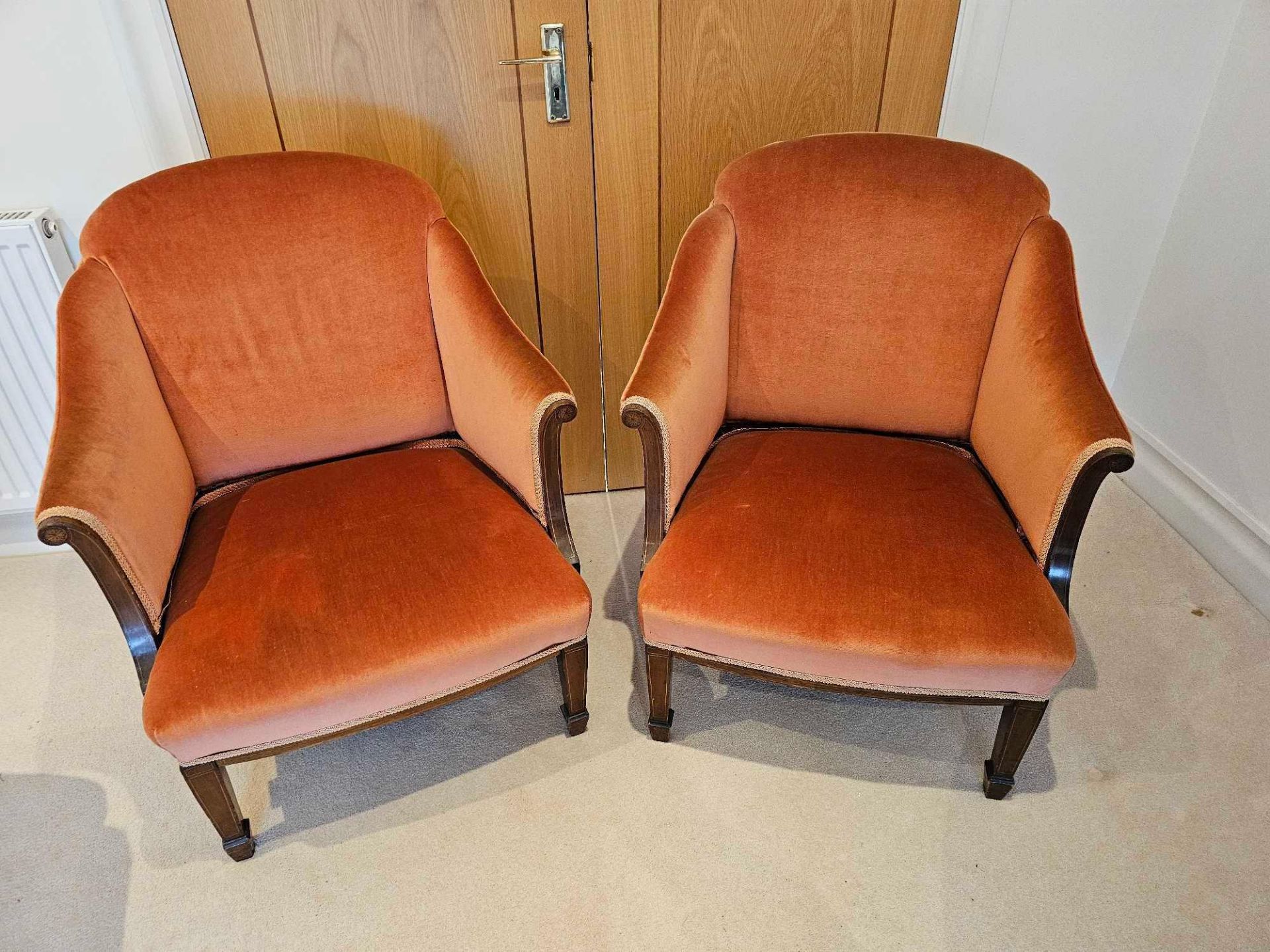 A Pair Of Edwardian Mahogany And Boxwood Strung BergÃ¨res Each Upholstered With Low Rectangular