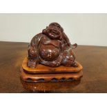 A Chinese Carved Soapstone Figure Of Hotei Seated On Rosewood Plinth 10cm Overall
