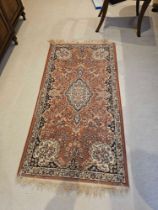 A Persian Keshan Style Rug The Pink Field With Lozenge Medallions And Scrolled Spandrels Within A