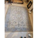 A Persian Patterned Rug The Ivory Field With Lozenge Medallions And Scrolled Spandrels With A