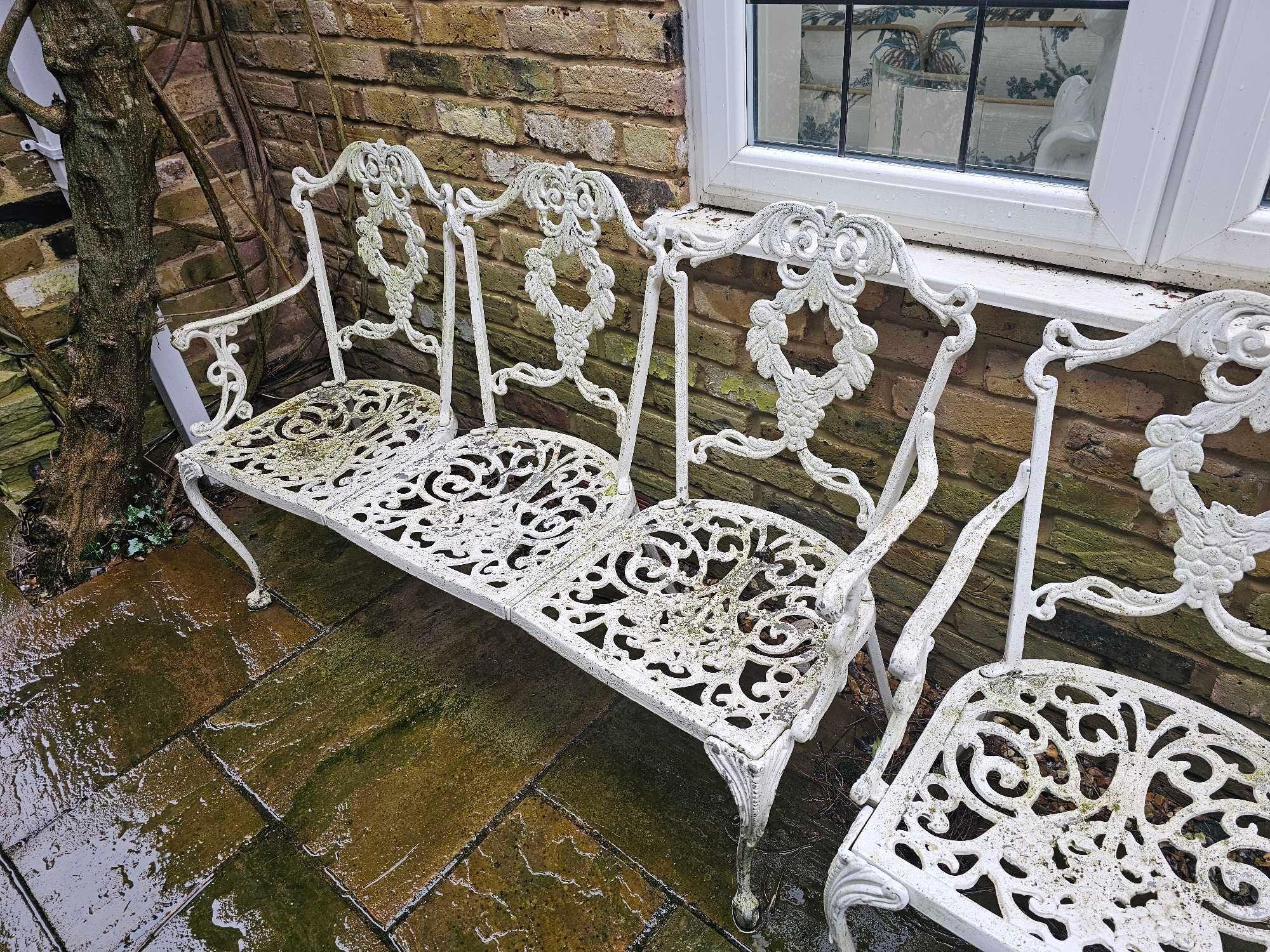 A Regency Style Cast Iron Garden Furntiure Set Comprising Of A Three Seater Love Bench And A Pair Of