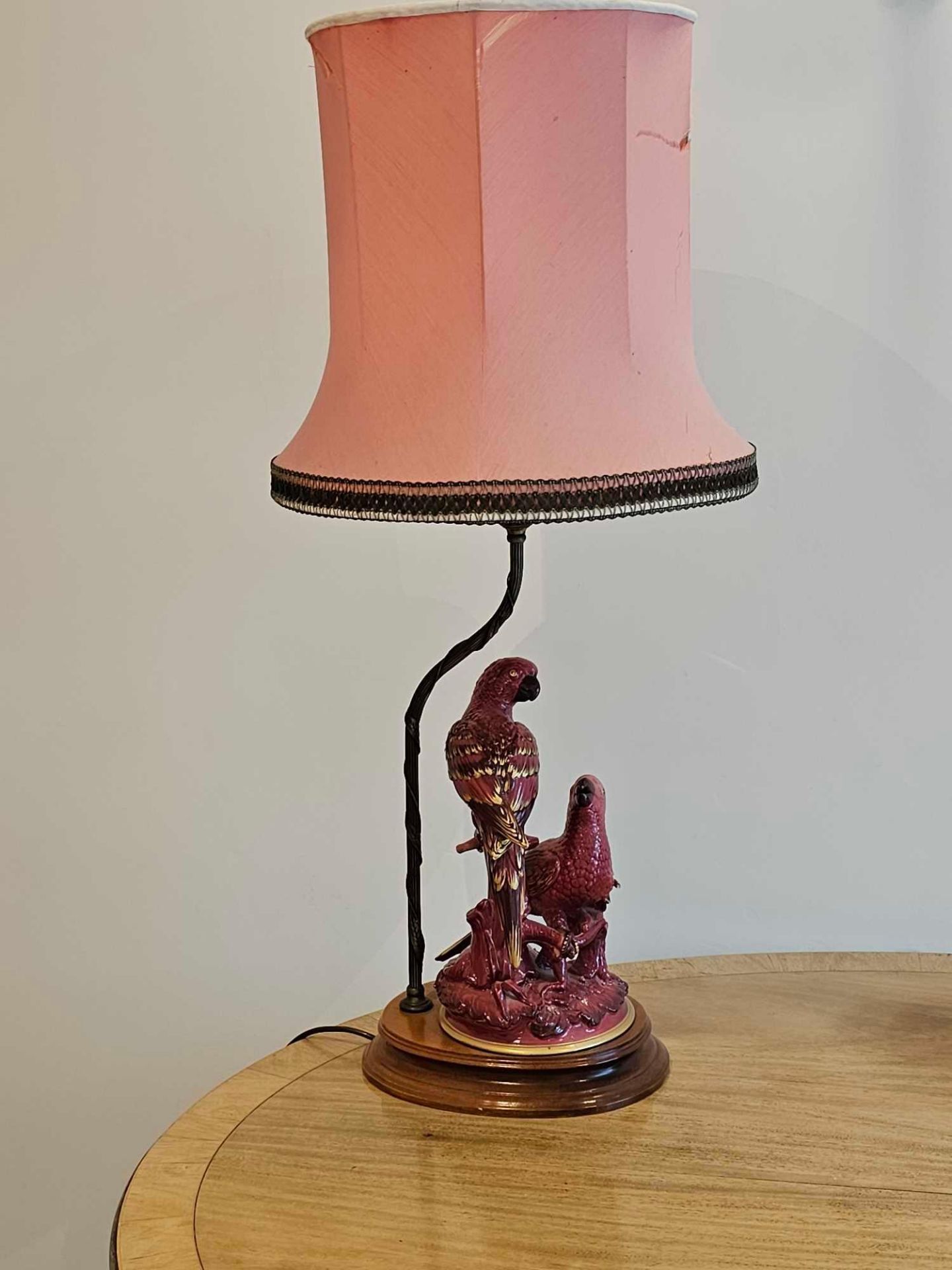 A Vintage Table Lamp Decorated With A Pair Of Painted Ceramic Parrots Sitting Upon A Wooden Base