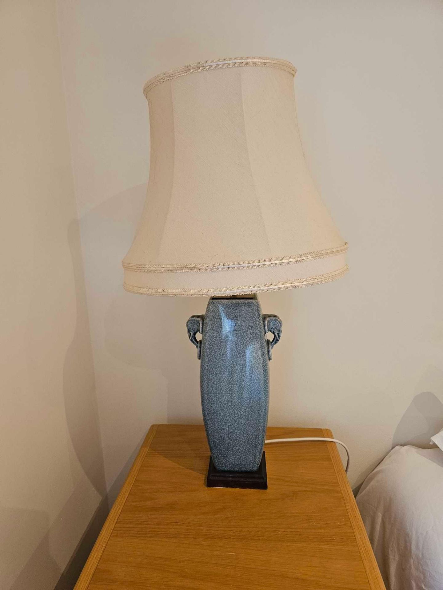 A Pair Of Ceramic Crackle Glazed Tall Table Lamps With Elephant Form Handles On Hardwood Base With