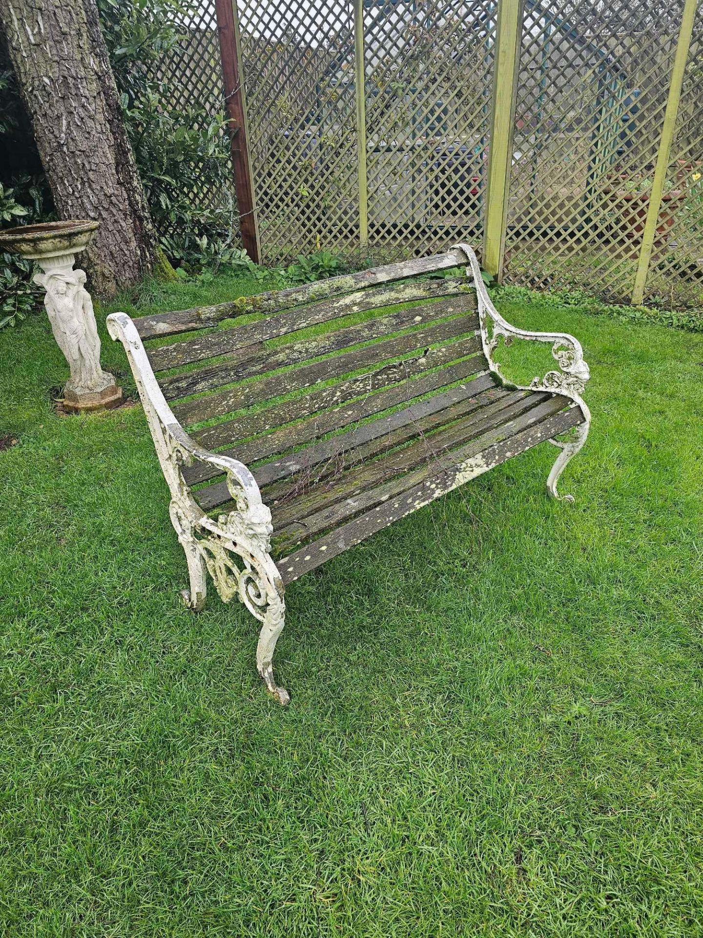 A Victorian Cast Iron Bench The Curved Wood Slats Raised On Monopodia Brackets
