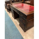 George III style mahogany pedestal desk. The rectangular top with a red leather and tooled insert,