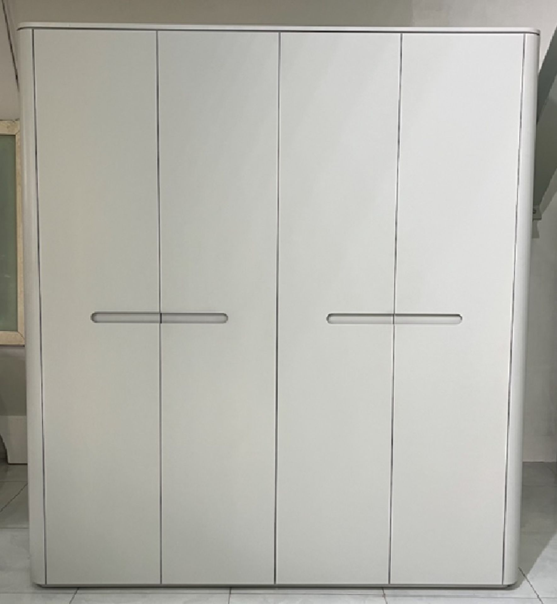 Florence Four Door Wardrobe This stylish four door wardrobe comes in a grey gloss lacquer finish