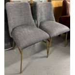 A set of contemporary dining chairs with gold finish effect legs and linen upholstery will add a