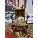 A Pair Of Oak Armchairs The Panelled Carved Back Below A Decorative Top Rail With A Tapestry