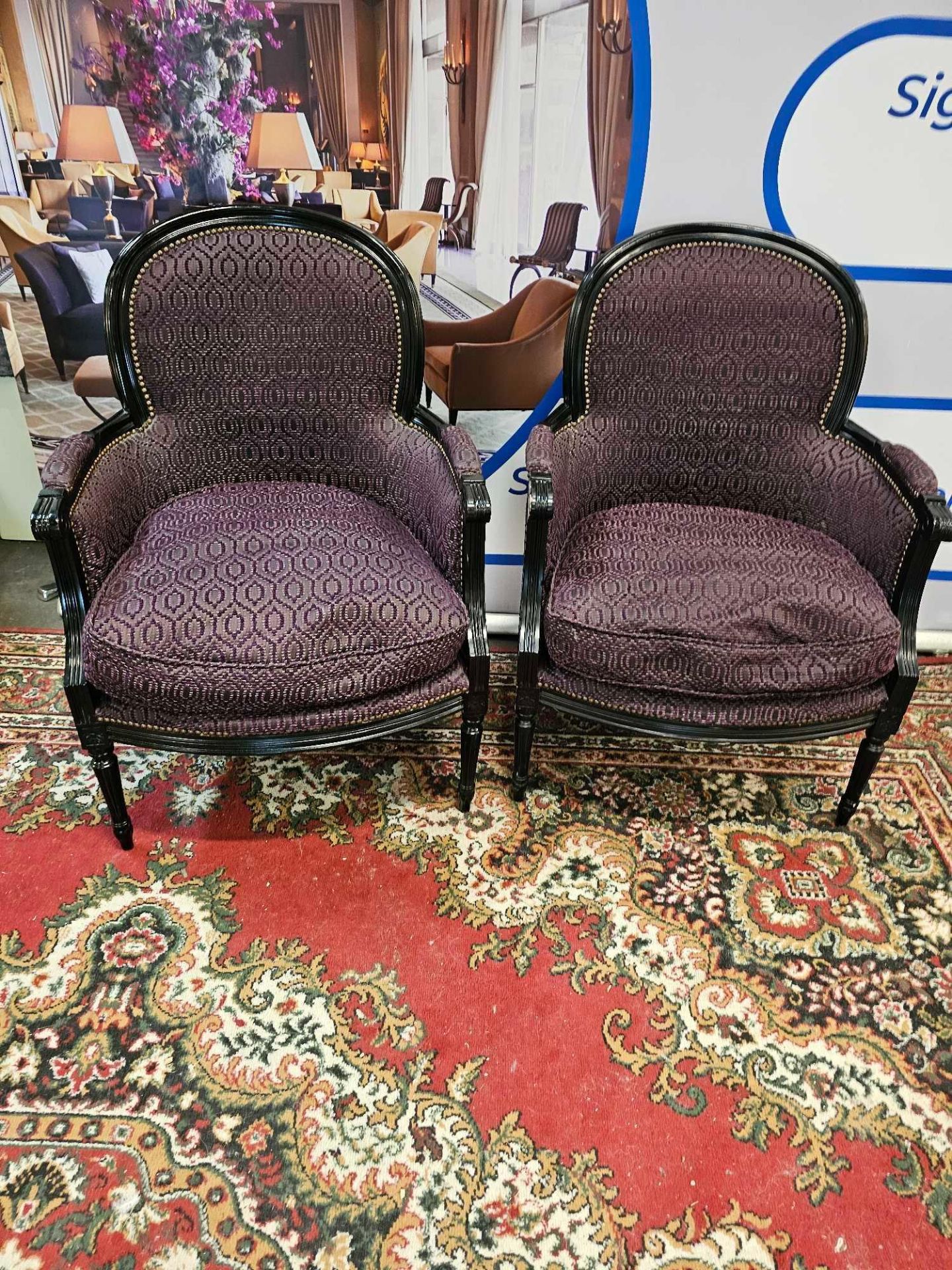 A Pair Of French Bergere Chairs, Louis XV-Style With A Polished Ebony Black Frame And Upholstered In