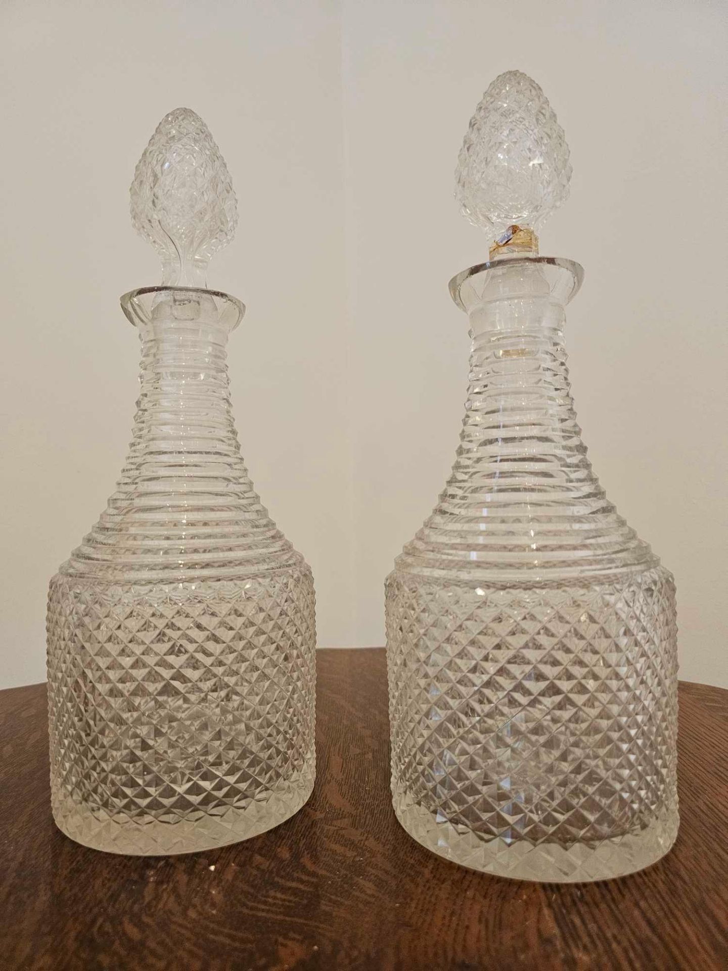 A Pair Fo Irish Crystal Decanters With Stoppers 34cm (A/F Both With Chips To Rim)