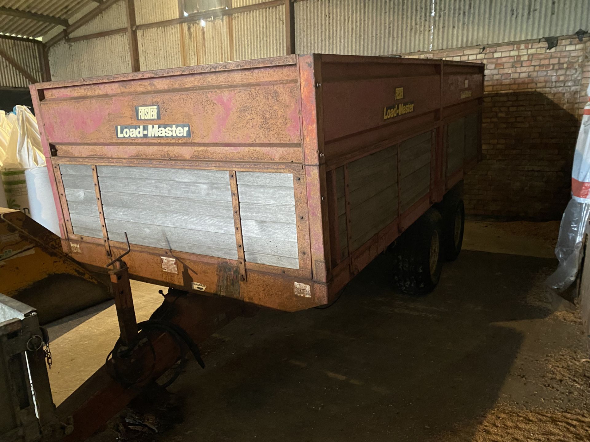 (82) Foster Load-Master 7 ton tipping trailer with dual axle with rocking beam, drop down sides with