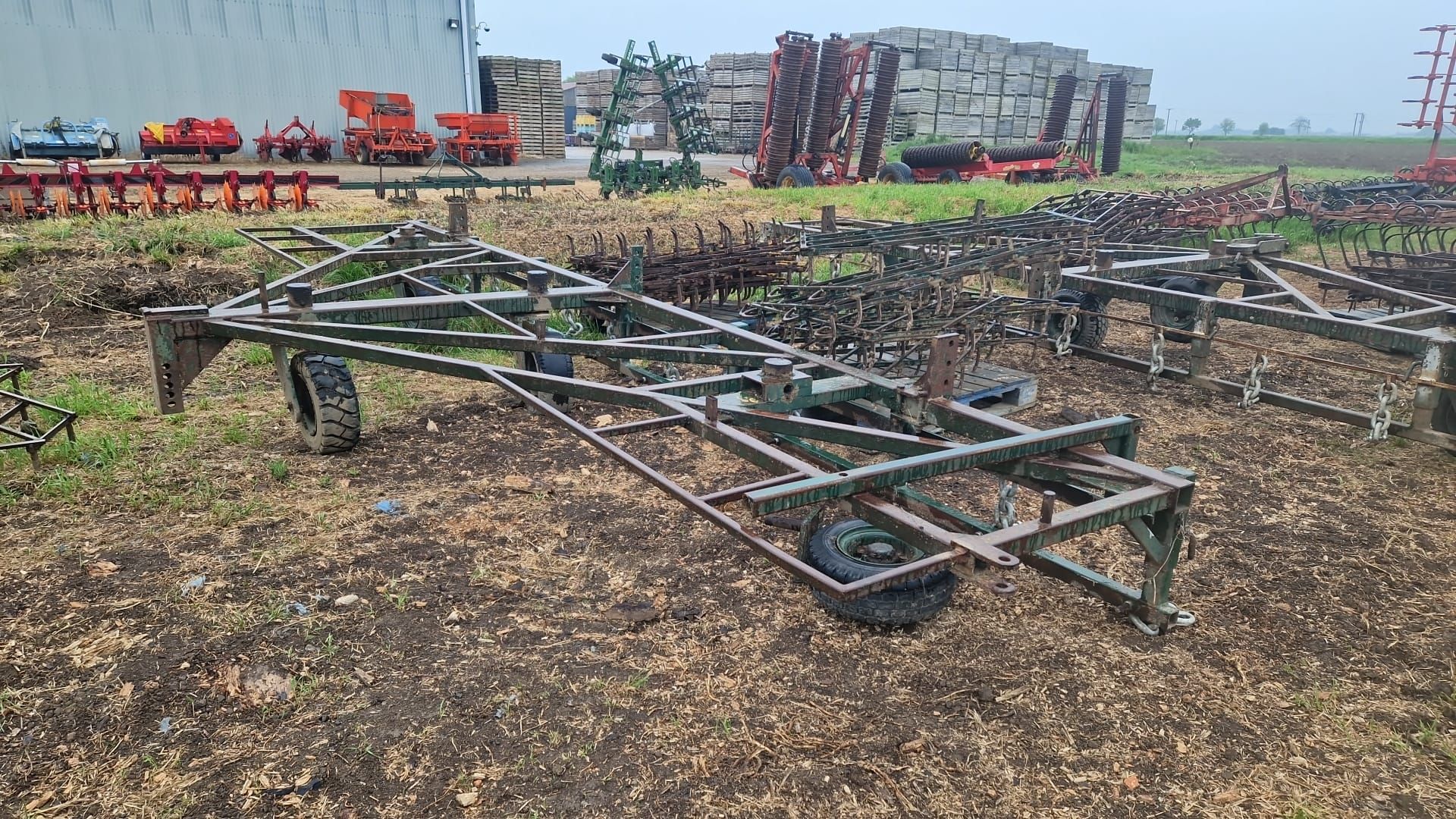 Trailed 6m harrow gantry on caster wheels with 3 sets of various weighted harrows