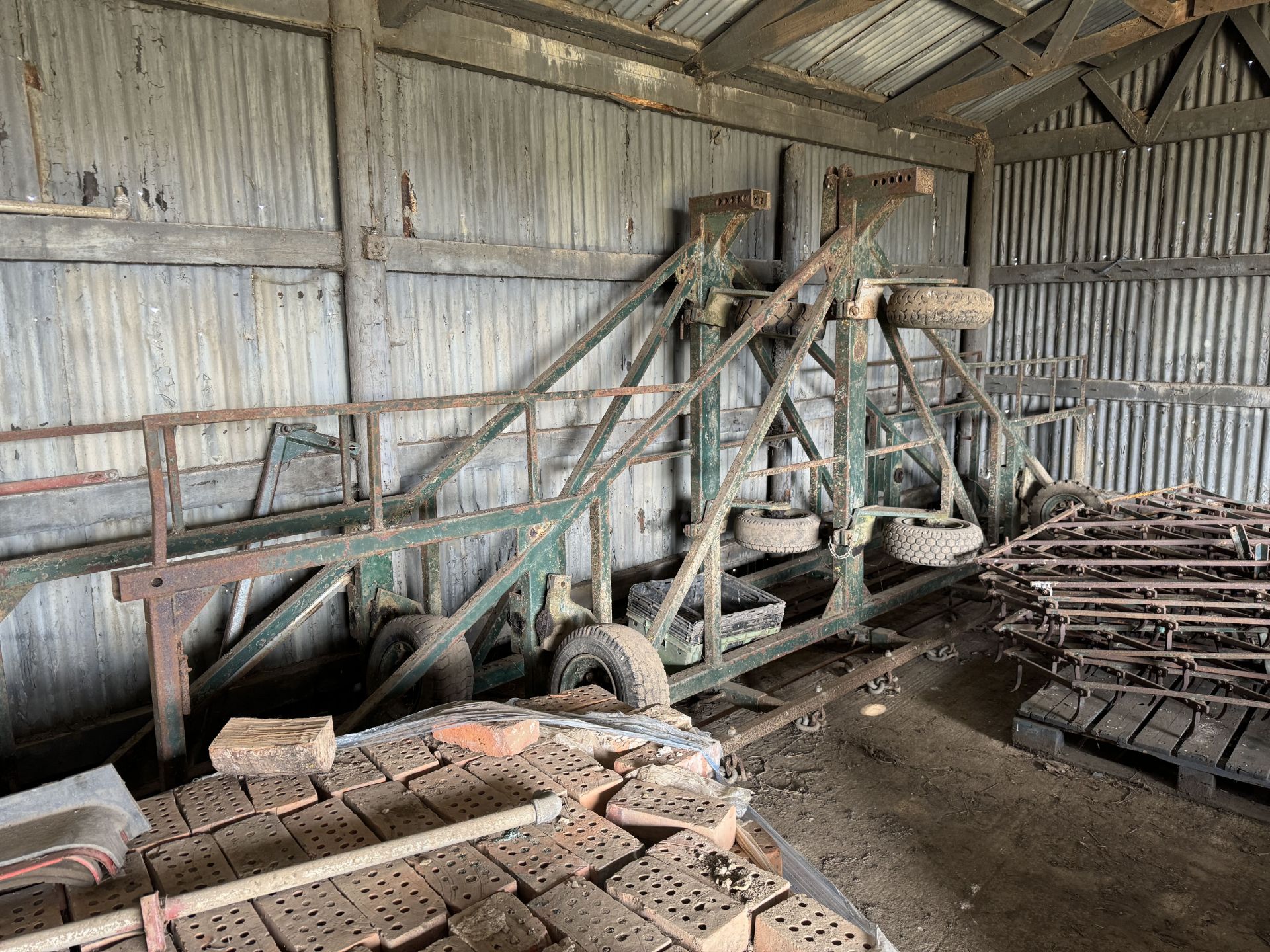 Trailed 6m harrow gantry on caster wheels with 3 sets of various weighted harrows