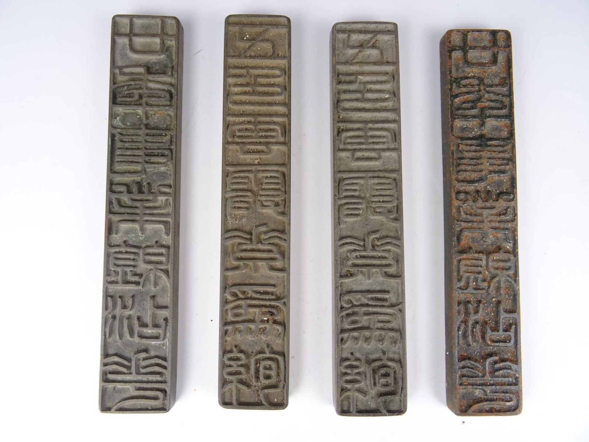 Four metal stamps