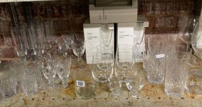 SHELF OF CUT GLASS CHAMPAGNE FLUTES, WINE GLASSES,