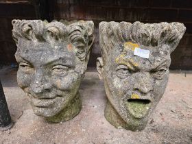 PAIR OF WEATHERED RECONSTITUTED STONE PLANTERS IN THE FORM OF FACES