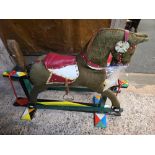 CHILD'S FABRIC COVERED ROCKING HORSE ON WOOD STAND