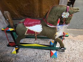 CHILD'S FABRIC COVERED ROCKING HORSE ON WOOD STAND