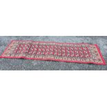 88" X 24" RED PATTERNED RUG