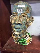 AN ETHNIC HEAD WITH NECKLACE
