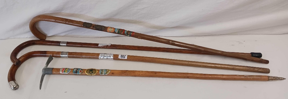 2 SWISS WALKING STICKS WITH BADGES & 2 CANES WITH SILVER COLLARS