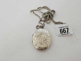 A LARGE SILVER HINGED LOCKET ON A SILVER CURB LINK NECK CHAIN