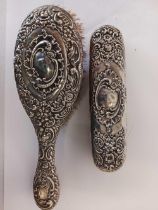 TWO VICTORIAN EMBOSSED SILVER BACK BRUSHES,