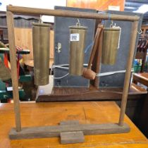WOODEN STAND WITH TRENCH ART GUN SHELLS & WOODEN BEATER