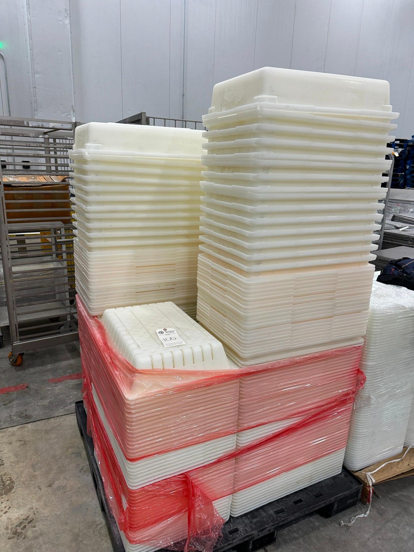 SKID OF FLAT AND PERFORATED PLASTIC TRAYS