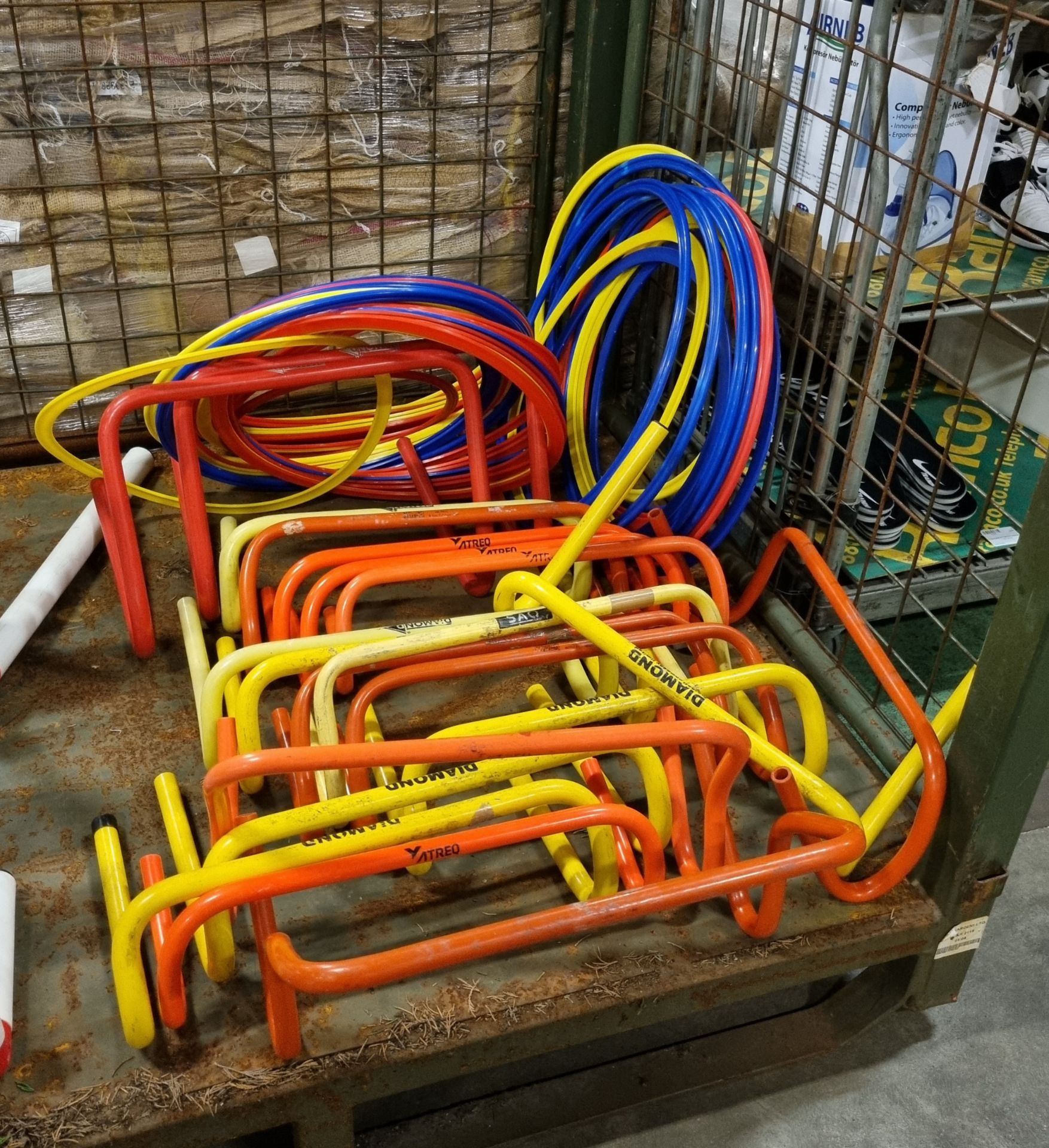 20x Plastic hurdles and approximately 50 multi coloured plastic rings