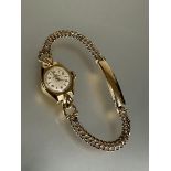 A ladys 9ct gold Uno wristwatch with silvered dial and baton and arabic hour markers and automatic