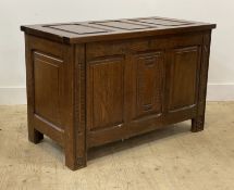 An early 20th century oak coffer of 18th century design, with three panel top and front enclosing