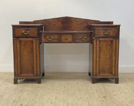 A late Georgian mahogany twin pedestal serving table, the arched ledge back above a bowed centre