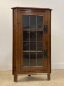 An oak corner cabinet, early 20th century, the lead camed glass door enclosing two shelves, on stile