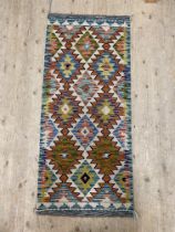 A Flat weave Chobi kilim runner rug of characteristic design 150cm x 65cm.