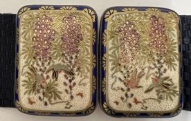 A Meiji/Taisho period Japanese Satsuma earthenware buckle decorated with wisteria and birds on a whi