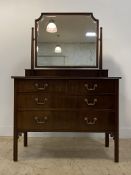 An Edwardian mahogany dressing chest, the bevelled swing mirror above two short and two long