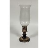 An Epns circular column storm lamp with chased scalloped base complete with glass shade, (H x 34