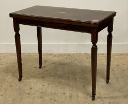 An Edwardian rosewood card table, the boxwood strung and marquetry top folding and revolving to