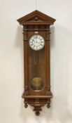 A late 19th century Vienna type regulator wall clock, with arched pediment above a glazed case,