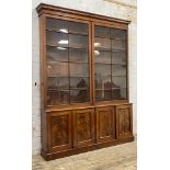 A Victorian mahogany library bookcase, the projecting cornice over two two astragal glazed doors