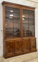 A Victorian mahogany library bookcase, the projecting cornice over two two astragal glazed doors