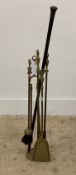 An early 20th century brass four piece fire side companion set, together with an early 20th