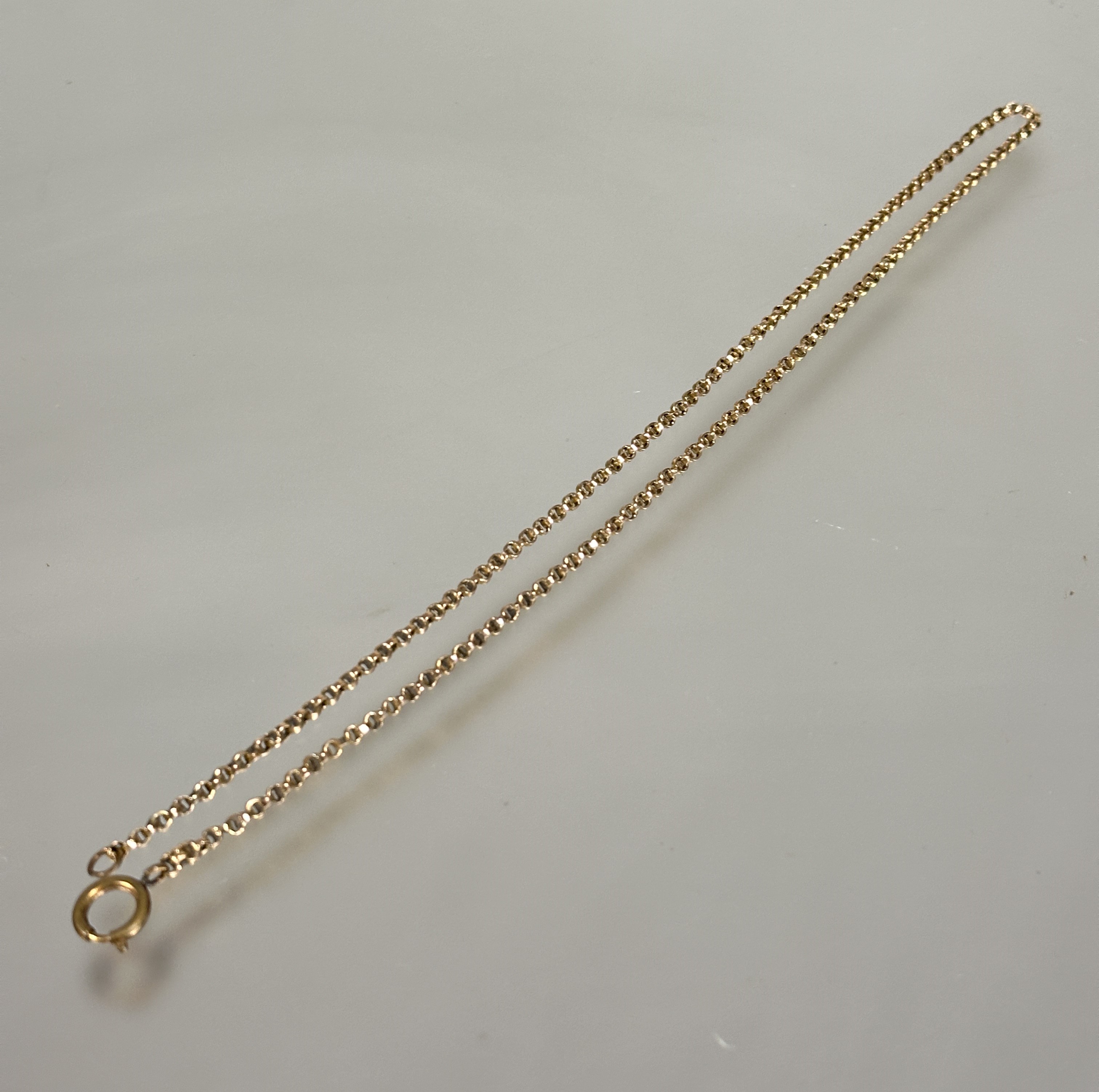 A 9ct gold belcher link guard chain mounted with brass clip fastening, (L x 26.5 cm) 8.5g